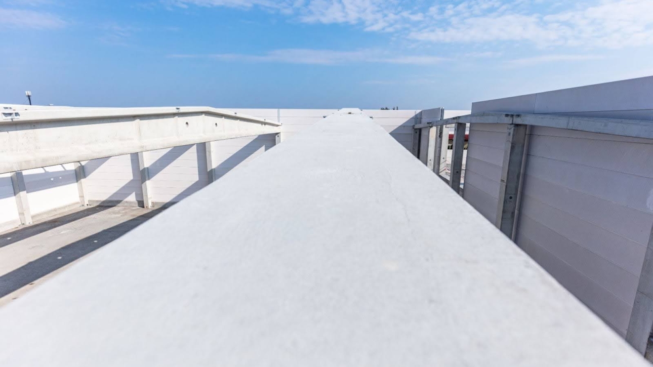 Large commercial warehouse with freshly installed white TPO roofing.