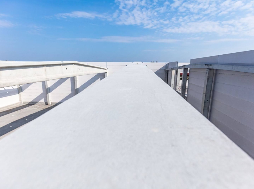 Large commercial warehouse with freshly installed white TPO roofing.