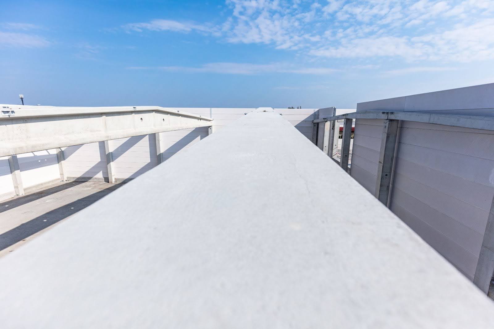 Large commercial warehouse with freshly installed white TPO roofing.