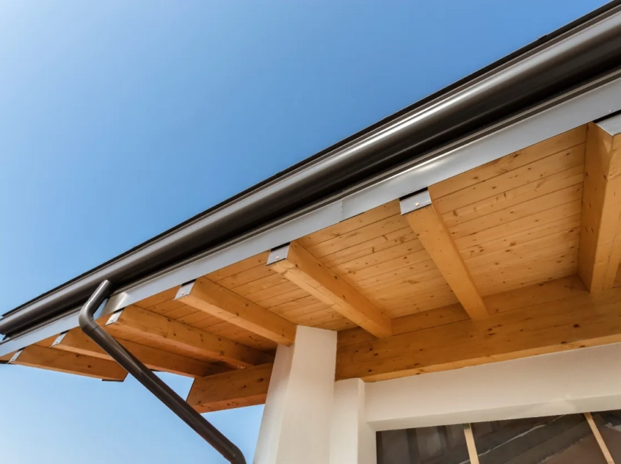 A cropped photo of new steel gutters on a home.