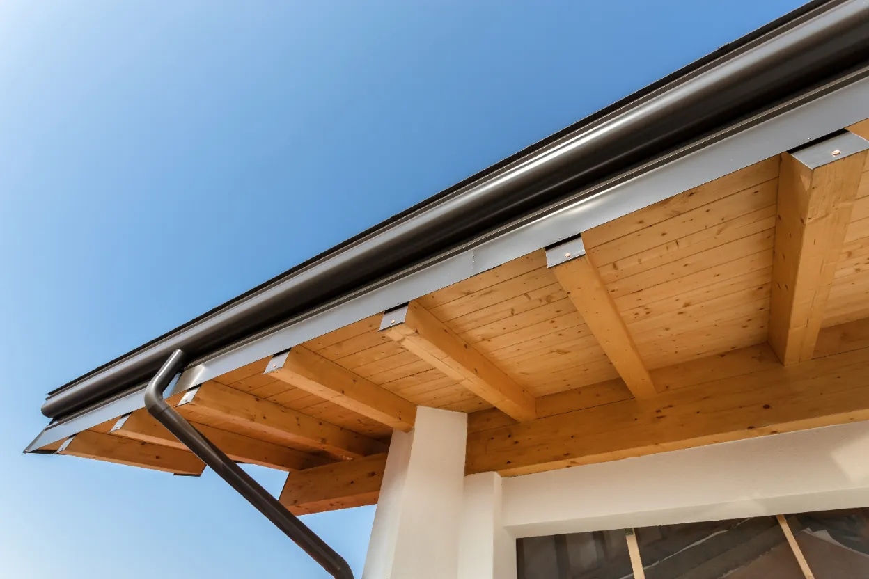 A cropped photo of new steel gutters on a home.