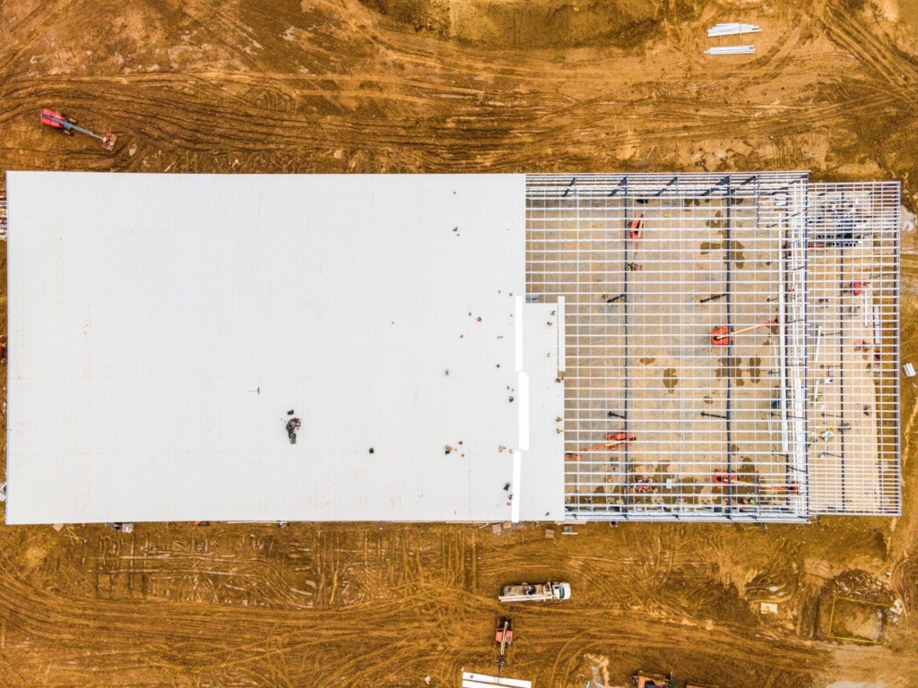 Aerial view of warehouse roof framework prepared for TPO installation.